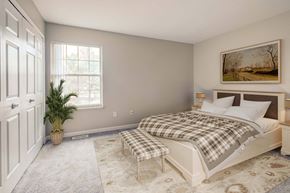 Stow apartment for rent - A bedroom with a bed, a bench, and a painting on the wall.