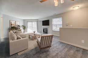 Westlake apartment for rent - A living room with a couch, chair, and television.