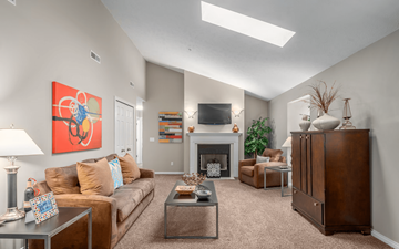 Middleburg Heights apartment for rent - A living room with a fireplace and a painting on the wall.