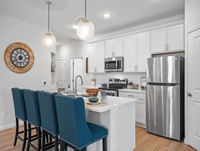 Parma Heights apartment for rent - a kitchen with a island and a stainless steel refrigerator