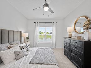 Parma Heights apartment for rent - a bedroom with a large bed and a ceiling fan