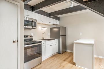 Delaware apartment for rent - A kitchen with white cabinets and stainless steel appliances.