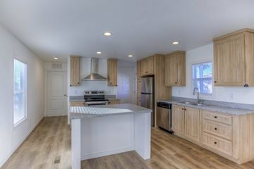 Tucson apartment for rent - A kitchen with wooden cabinets and a white island.