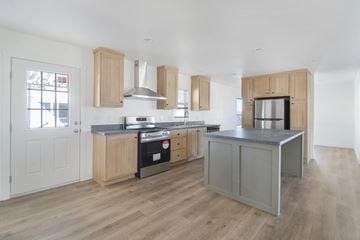 Glendale apartment for rent - A kitchen with wooden cabinets and a grey island.