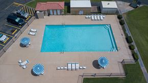 Glendale apartment for rent - An aerial view of a swimming pool surrounded by sun loungers and umbrellas.