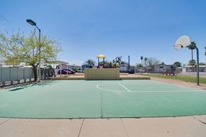 Tucson apartment for rent - A basketball court with a green surface and a white hoop.