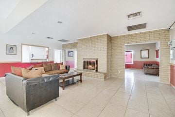Tucson apartment for rent - A living room with a grey couch and a fireplace.