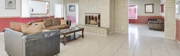 Tucson apartment for rent - A living room with a grey couch and a fireplace.