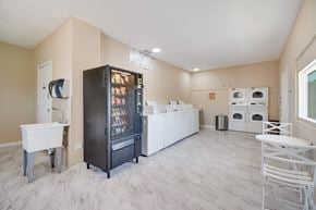 Tucson apartment for rent - A kitchen with a black fridge and white cabinets.