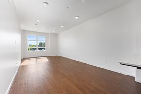 Bakersfield apartment for rent - A large empty room with wooden floors and white walls.