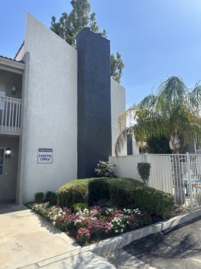 Bakersfield apartment for rent - a building with a flower garden in front of it