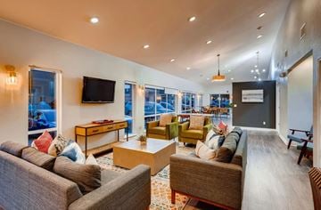 Lakewood apartment for rent - a living room with couches and chairs and a television