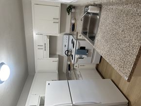 Bakersfield apartment for rent - a small kitchen with a white counter top and a sink