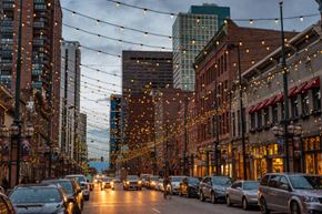 Lakewood apartment for rent - a city street filled with cars and lights on a cloudy day