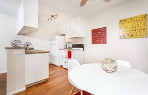 Fresno apartment for rent - a kitchen with white appliances and a white dining table