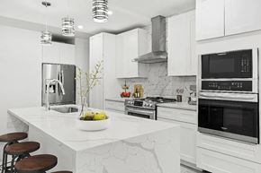 Brooklyn apartment for rent - A modern kitchen with a marble countertop and stainless steel appliances.