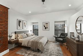 Brooklyn apartment for rent - A bedroom with a brick wall and a large bed.