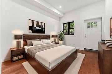 Brooklyn apartment for rent - A bedroom with a large bed and a painting on the wall.