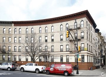 Brooklyn apartment for rent - A red van is parked on the side of the road.