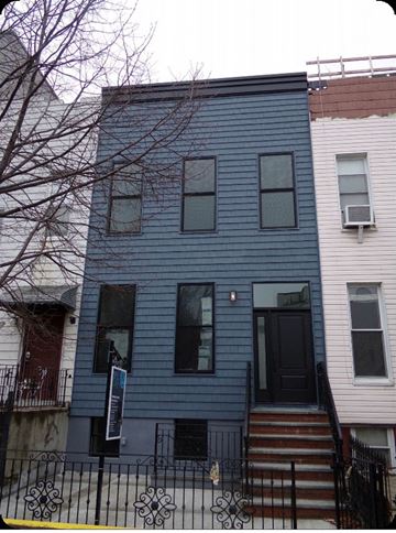 Brooklyn apartment for rent - A blue house with a black door and a sign on the front.
