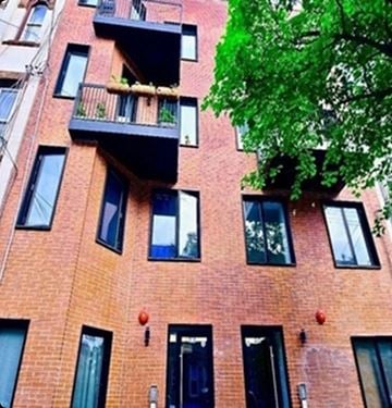 Brooklyn apartment for rent - A red brick building with black windows and balconies.