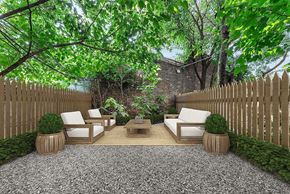 Brooklyn apartment for rent - A backyard with a white couch and a coffee table.