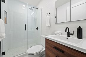 Brooklyn apartment for rent - A white toilet sits next to a sink in a modern bathroom.