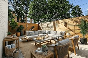 Brooklyn apartment for rent - A patio with a couch, chairs, and a table with a potted plant on it.