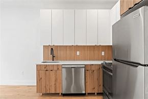 Brooklyn apartment for rent - A modern kitchen with wooden cabinets and stainless steel appliances.