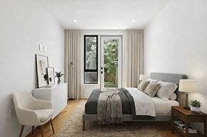 Brooklyn apartment for rent - A well-lit bedroom with a large bed and a chair.
