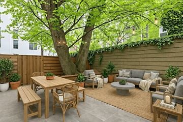Brooklyn apartment for rent - A backyard with a wooden table and chairs.
