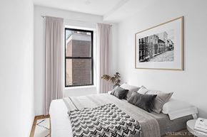 Brooklyn apartment for rent - A bedroom with a large bed and a picture on the wall.