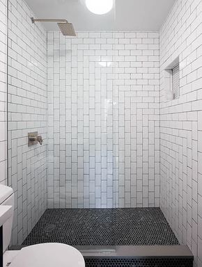 Brooklyn apartment for rent - A white tiled bathroom with a toilet and a walk in shower.