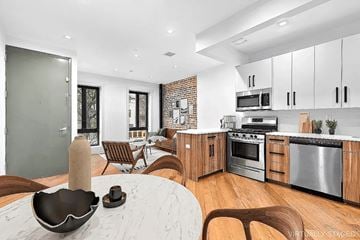 Brooklyn apartment for rent - A modern kitchen with wooden cabinets and stainless steel appliances.
