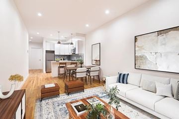 Brooklyn apartment for rent - A modern living room with a white sofa and a coffee table.