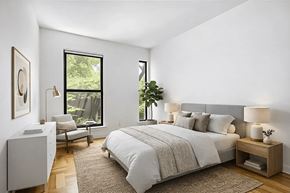 Brooklyn apartment for rent - A bedroom with a large bed and a chair by the window.