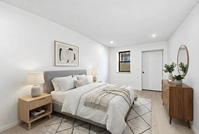 Brooklyn apartment for rent - A bedroom with a bed, nightstand, and a mirror.