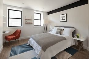 Brooklyn apartment for rent - A bedroom with a large bed and a red chair.