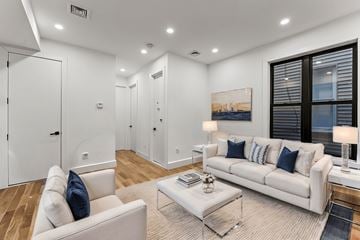 Brooklyn apartment for rent - A living room with a white couch and a glass coffee table.