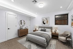 Brooklyn apartment for rent - A bedroom with a large bed, a chair, and a mirror.