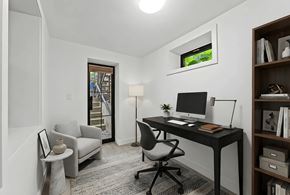 Brooklyn apartment for rent - A modern home office with a desk, chair, and bookshelf.