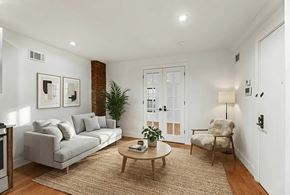 Brooklyn apartment for rent - A living room with a grey couch, a wooden coffee table, and a chair.