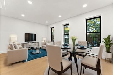 Brooklyn apartment for rent - A modern living room with a glass table and chairs.