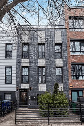 Brooklyn apartment for rent - A grey building with a black gate in front.