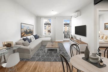 Brooklyn apartment for rent - A living room with a grey couch and a painting on the wall.