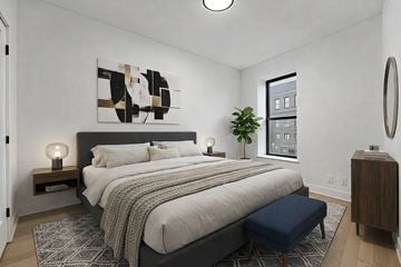 Brooklyn apartment for rent - A bedroom with a large bed and a painting on the wall.