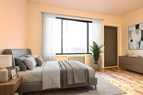 New York apartment for rent - A bedroom with a large bed, a nightstand with a lamp, a plant, and a painting on the wall.