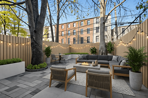 Brooklyn apartment for rent - A patio with a couch, chairs, and a fire pit.