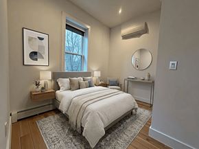 Brooklyn apartment for rent - A bedroom with a bed, nightstand, and a window.