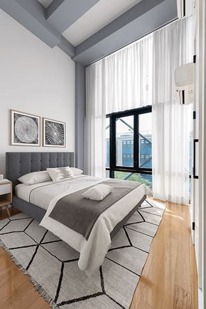 Brooklyn apartment for rent - A bedroom with a large bed and a window overlooking a cityscape.